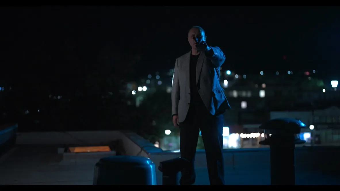 Ben on a call on the rooftop at night
